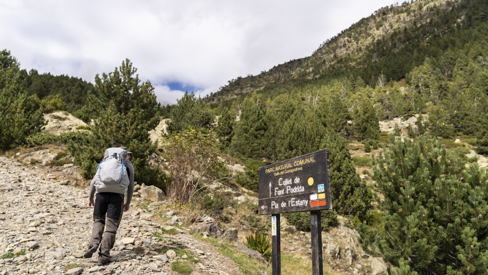 a person with a backpack walking up a hill