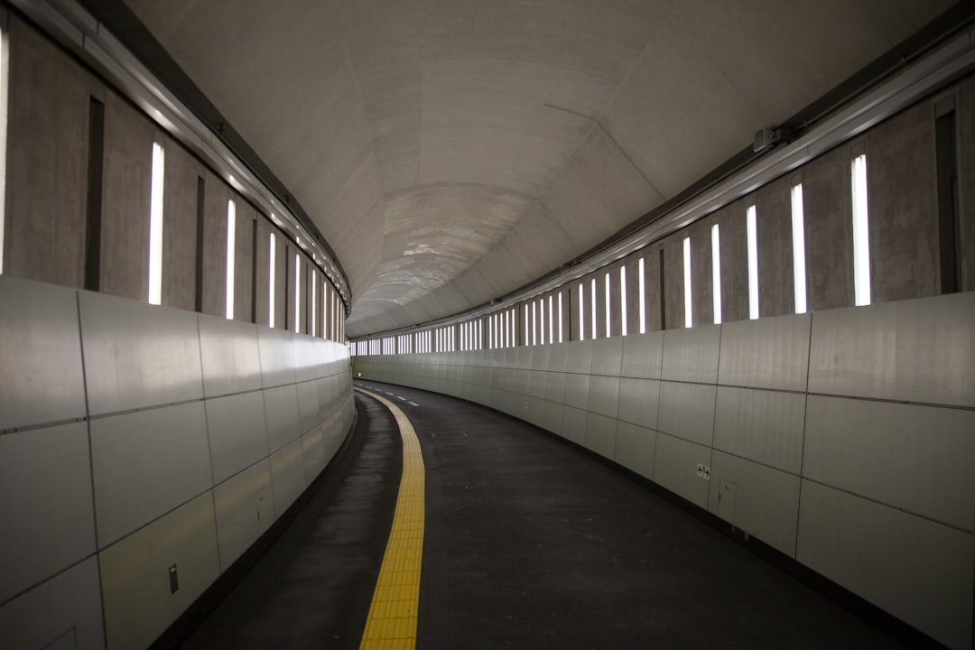 a long tunnel with a yellow line going through it,