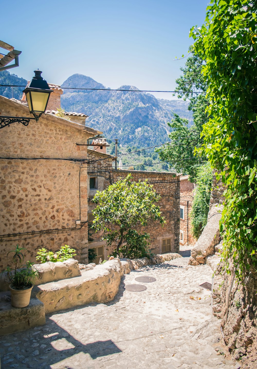 a cobblestone street leading to a stone building