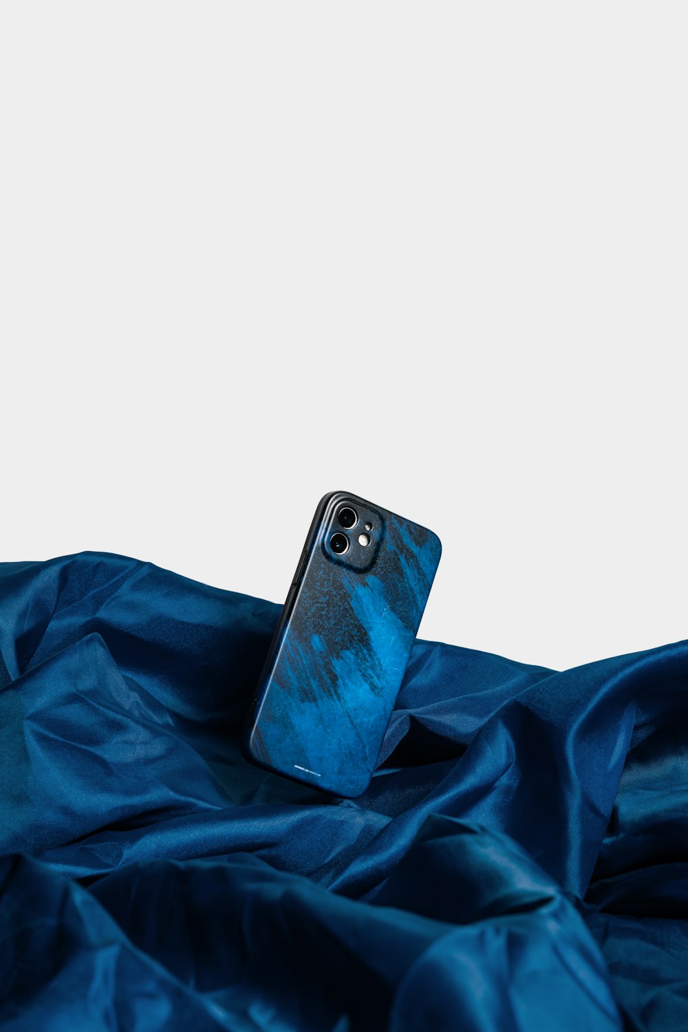 a cell phone sitting on top of a blue cloth