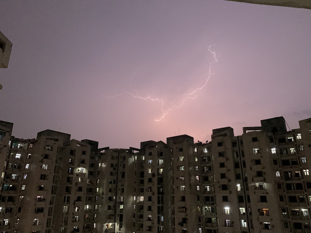 a large building with a lightning bolt in the sky