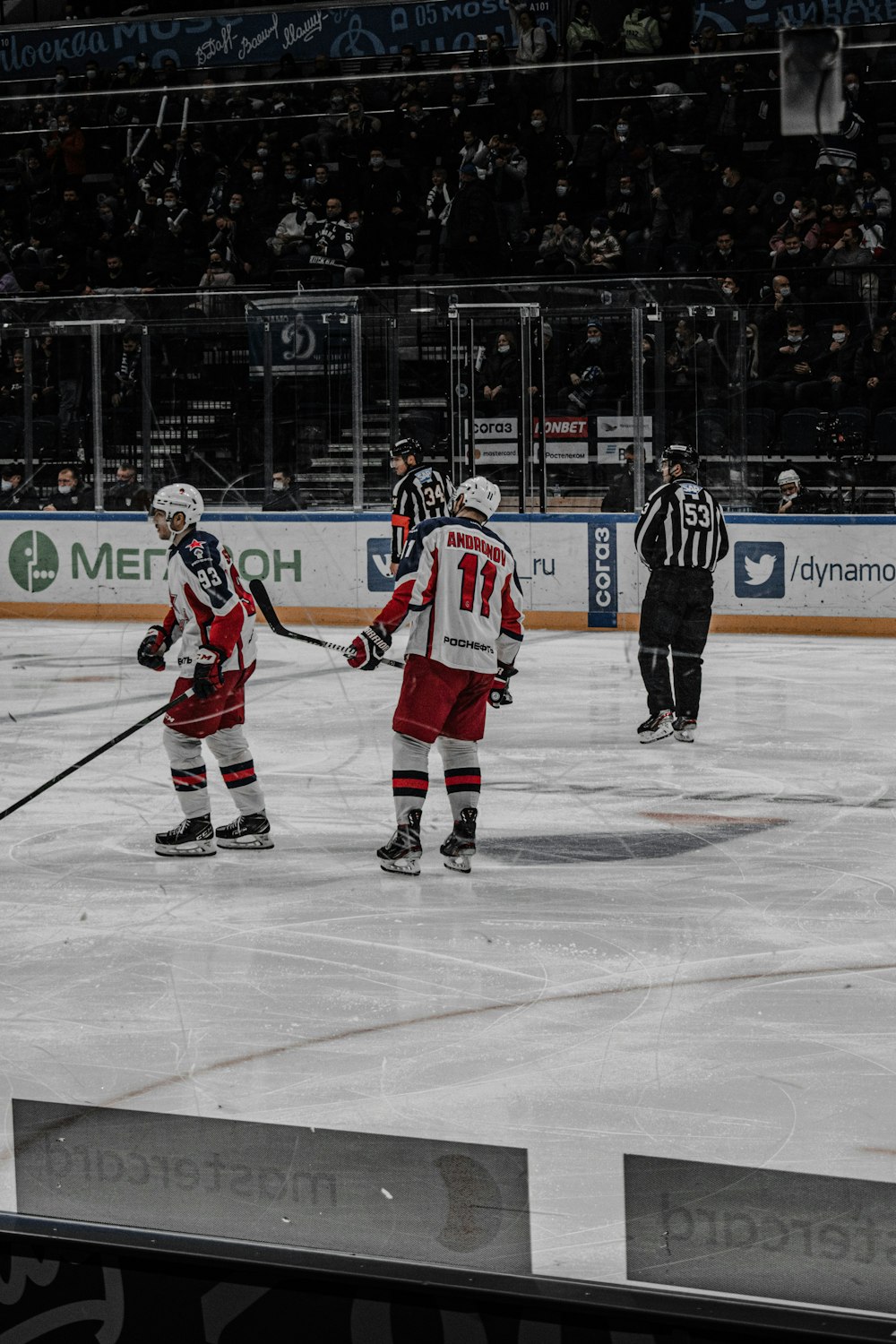 a group of people playing a game of ice hockey