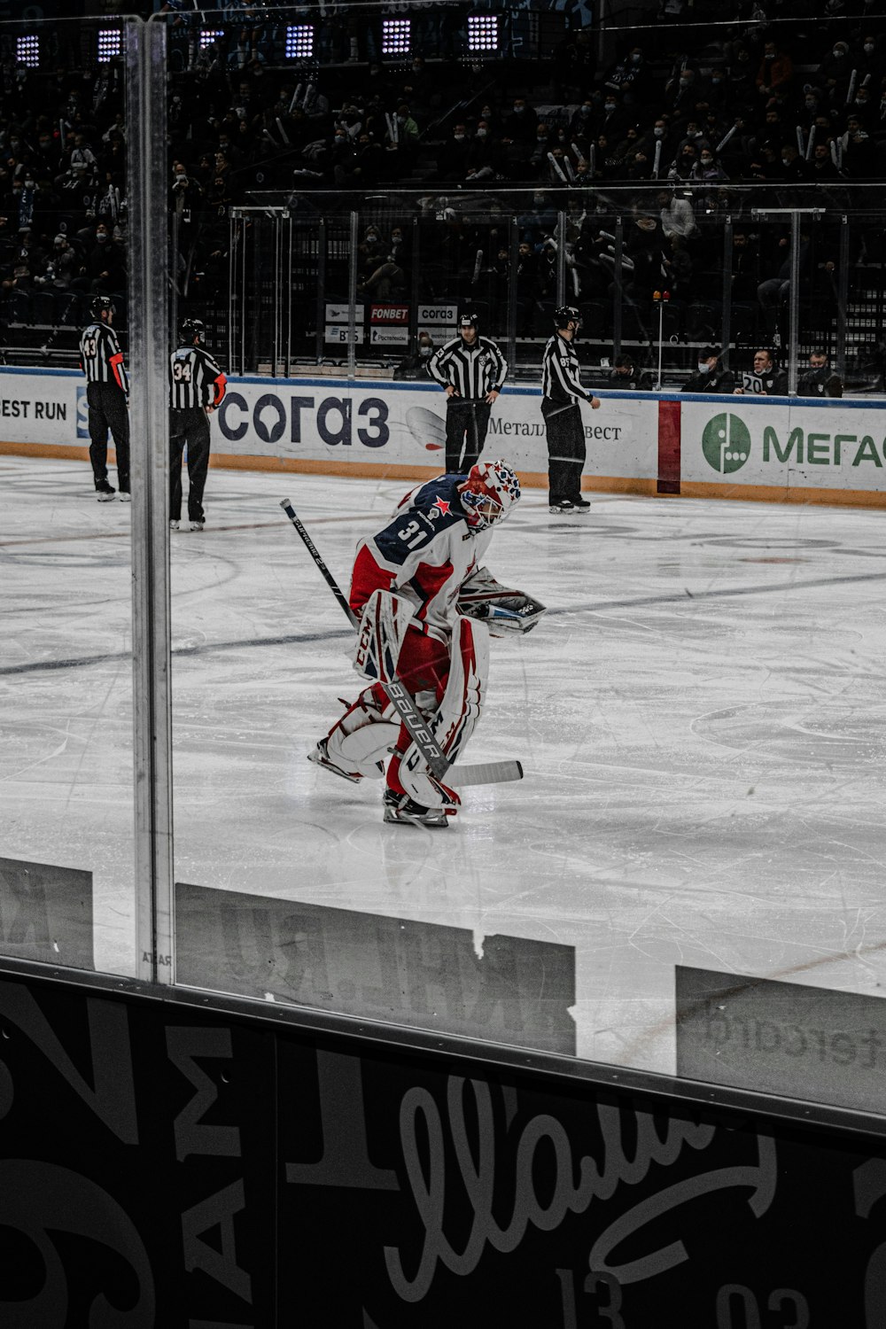 a hockey game is being played on an ice rink