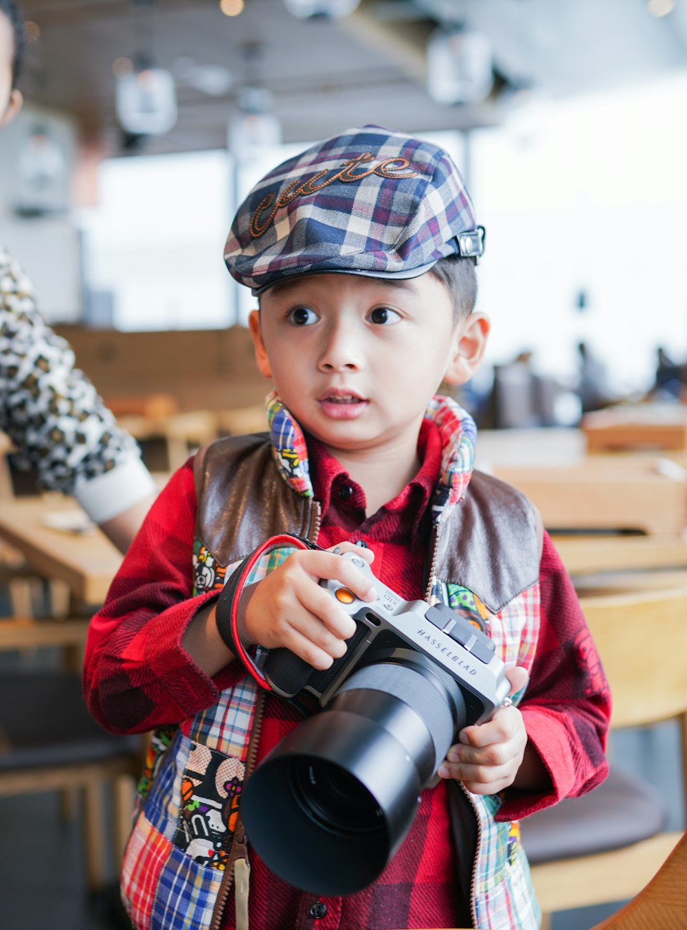 a young boy is holding a camera and taking a picture