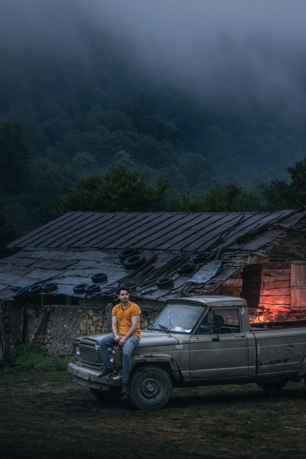 a man sitting on the back of a pick up truck