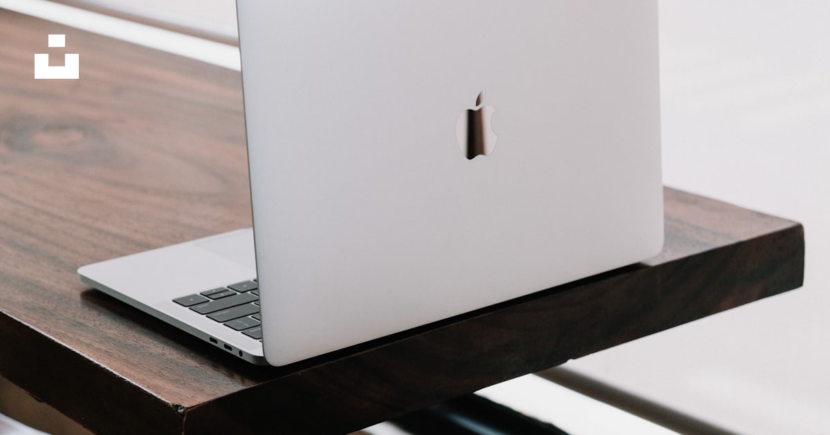 A white apple laptop sitting on top of a wooden desk photo – Free ...