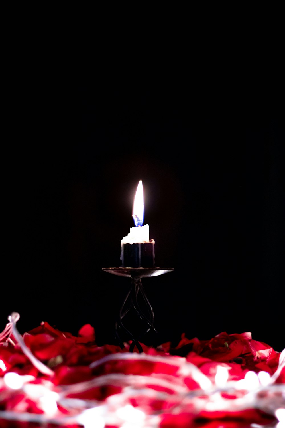 a lit candle sitting on top of a table