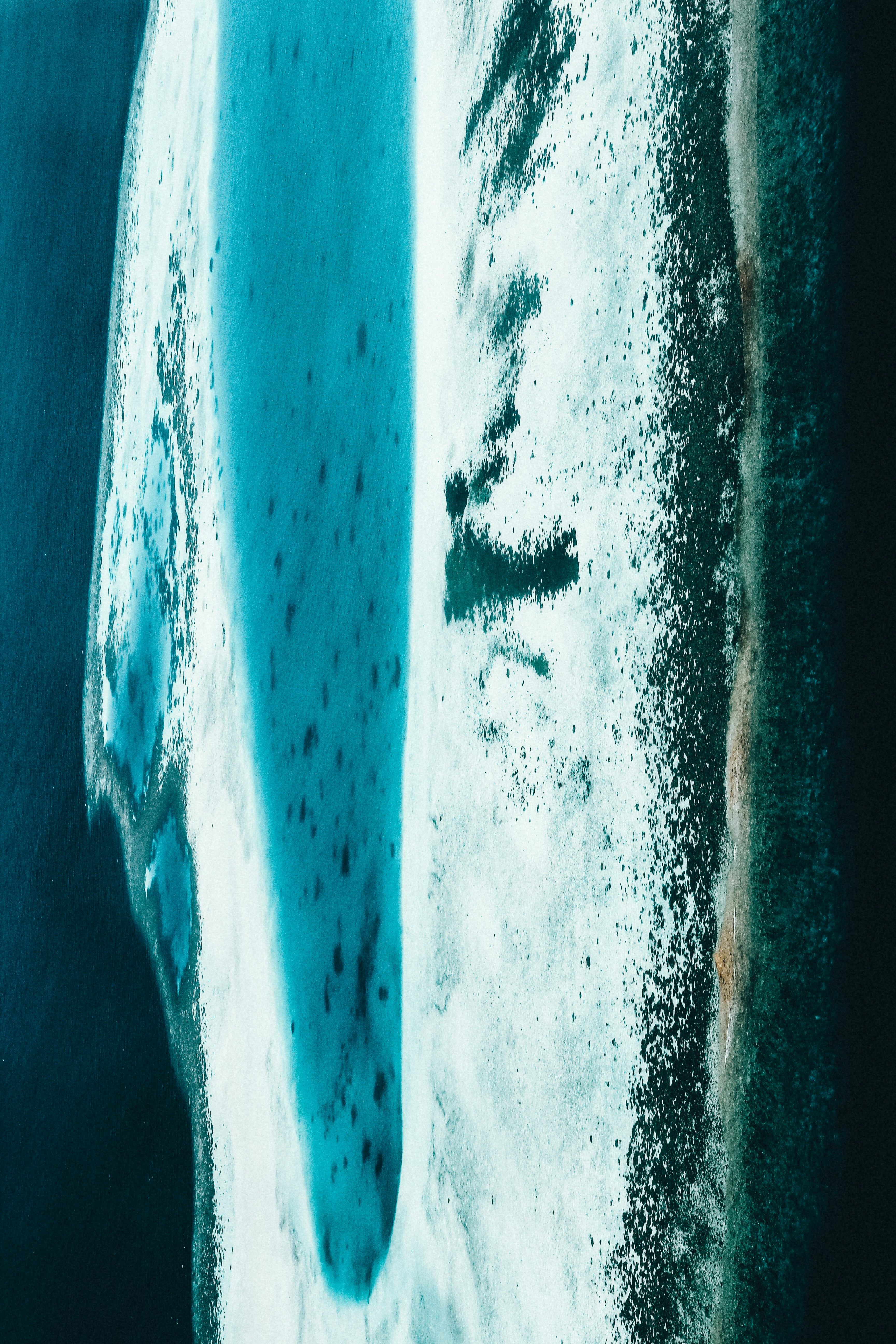 an aerial view of an iceberg in the ocean