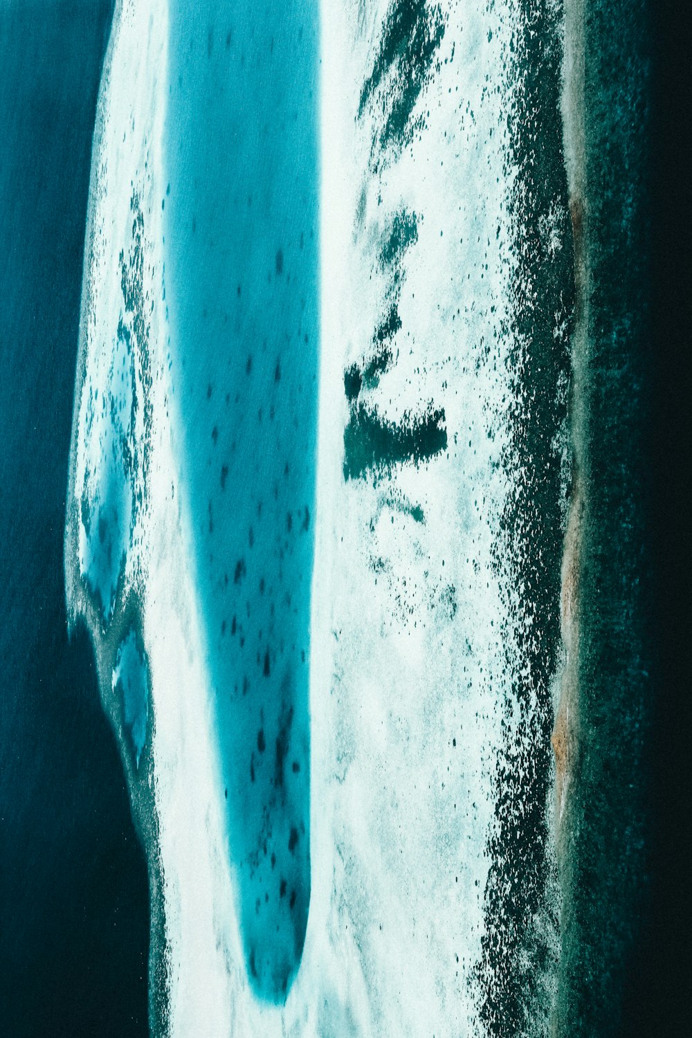an aerial view of an iceberg in the ocean