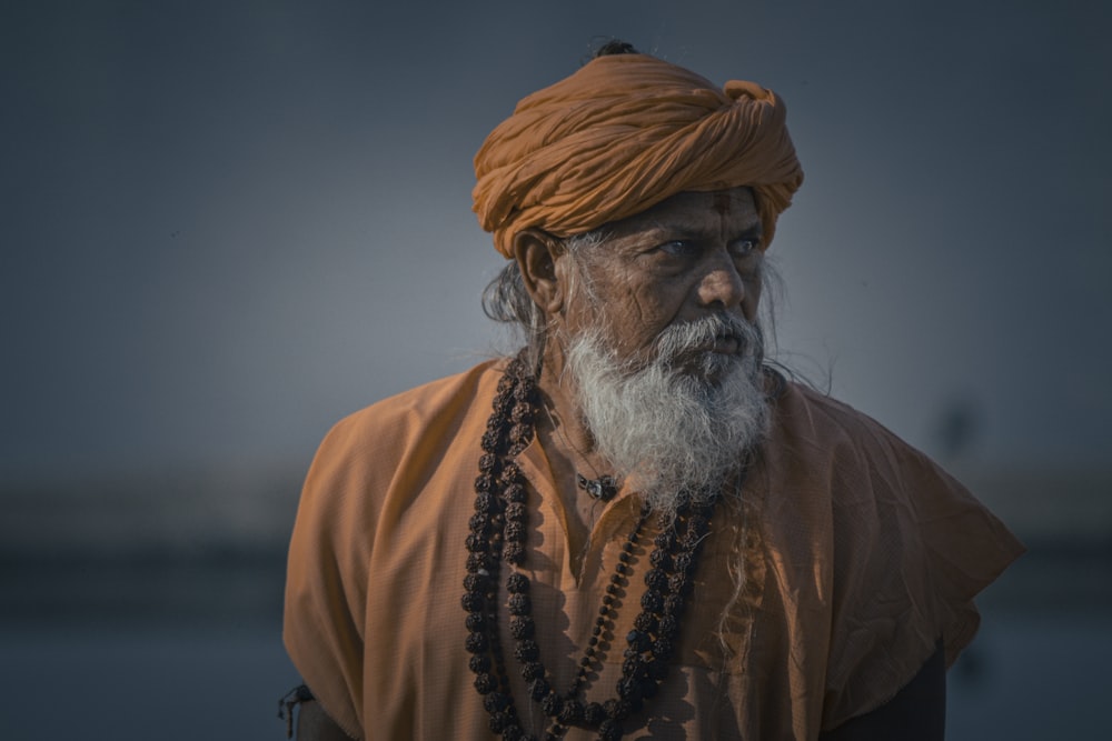 a man with a white beard wearing a turban