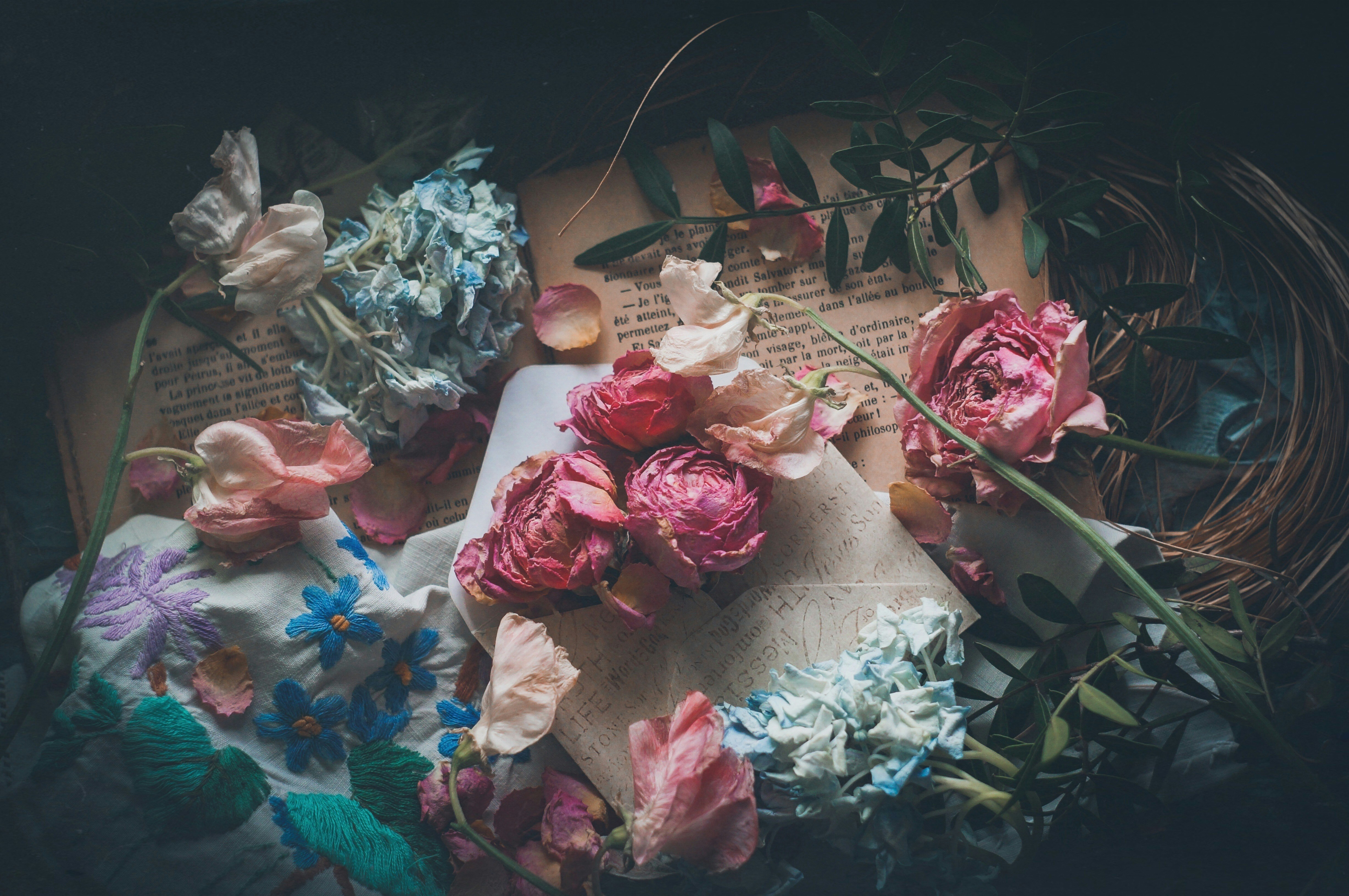 a bunch of flowers laying on top of a book