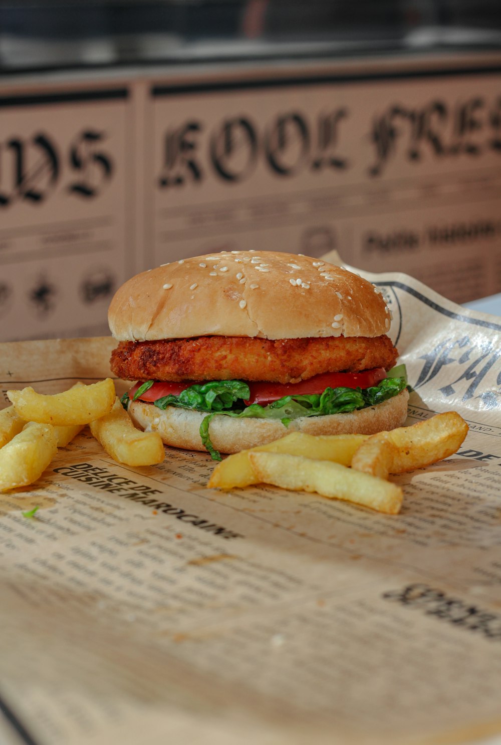a chicken sandwich with lettuce and tomato and french fries