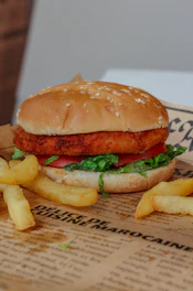 Golden crispy chicken burger with fresh lettuce and tomato on a soft bun
