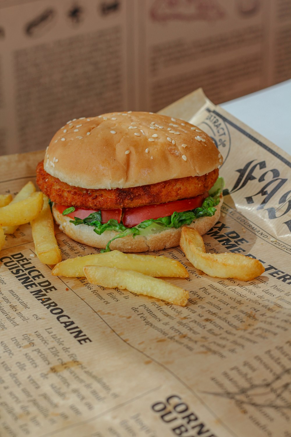 a sandwich and french fries on a newspaper