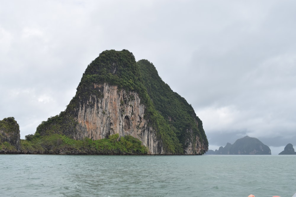 a large rock in the middle of a body of water