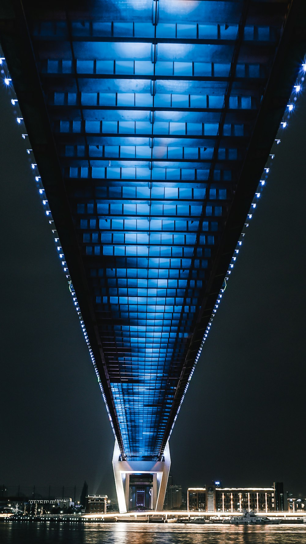 a view of the underside of a bridge at night