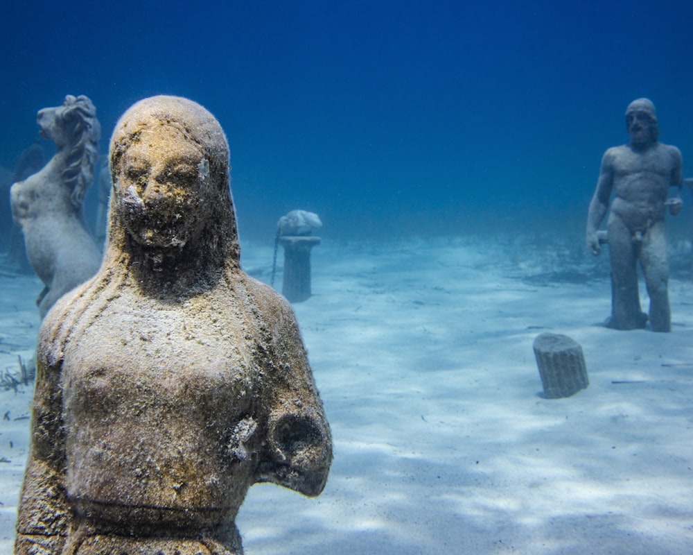 a statue of a man and a woman in the water