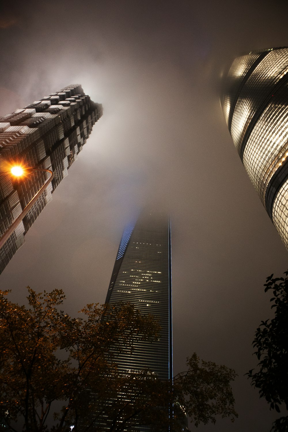 a very tall building towering over a city at night