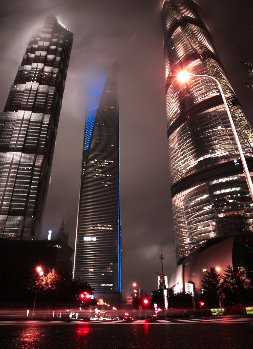 two tall buildings in a city at night