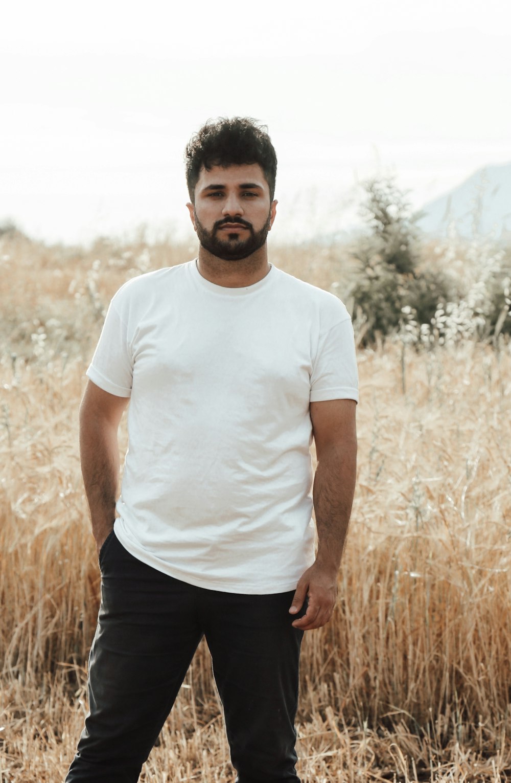 a man standing in a field of tall grass