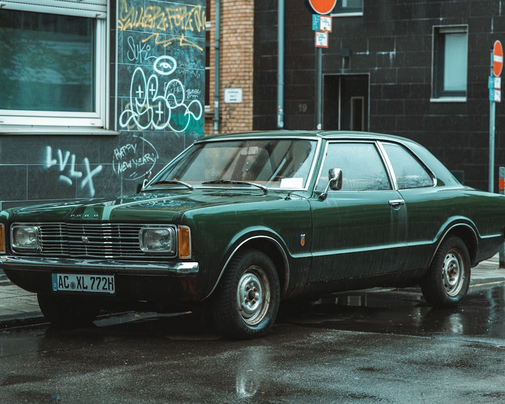 a green car parked on the side of the road