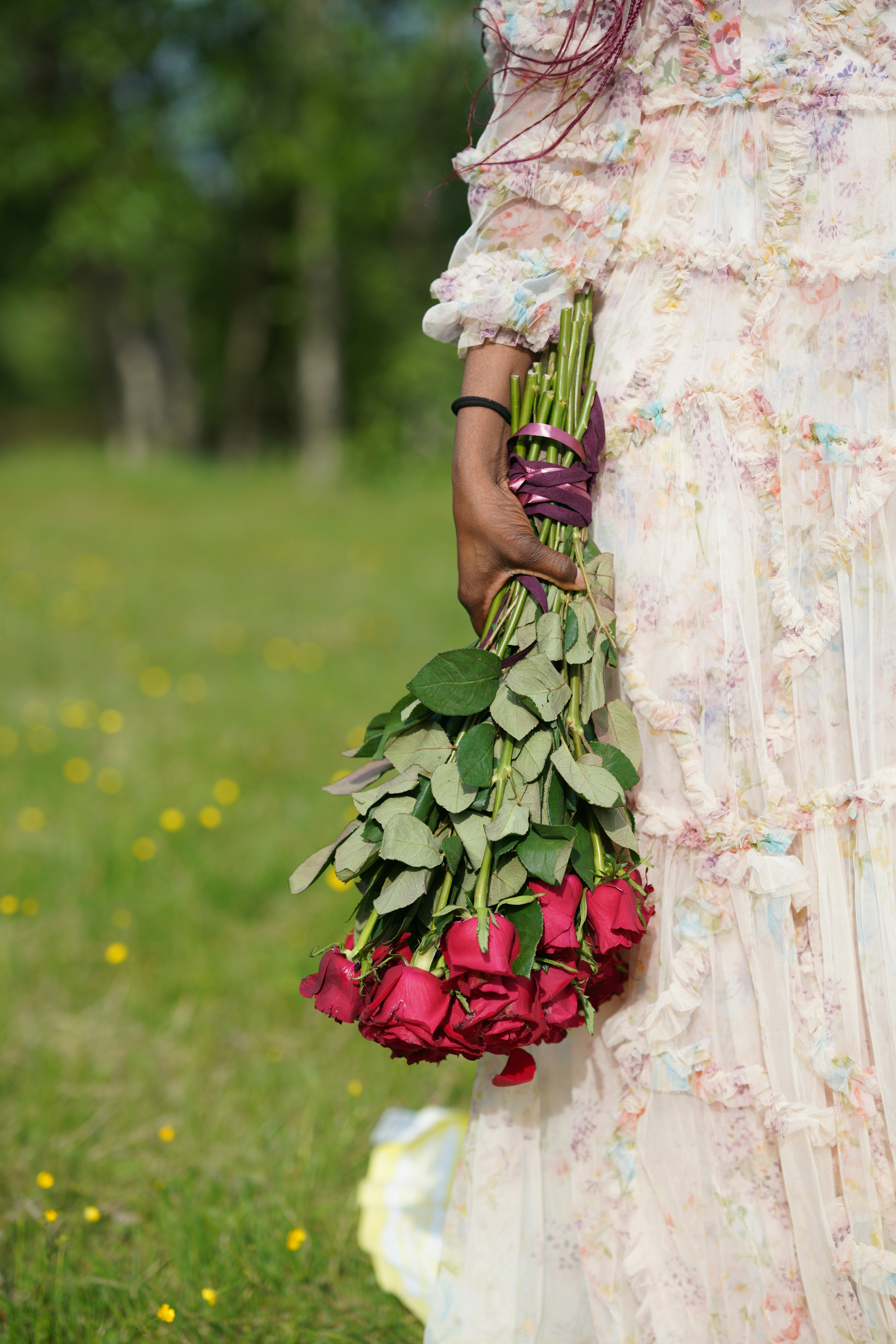 A woman in a dress holding a bouquet of flowers photo – Free Flower ...