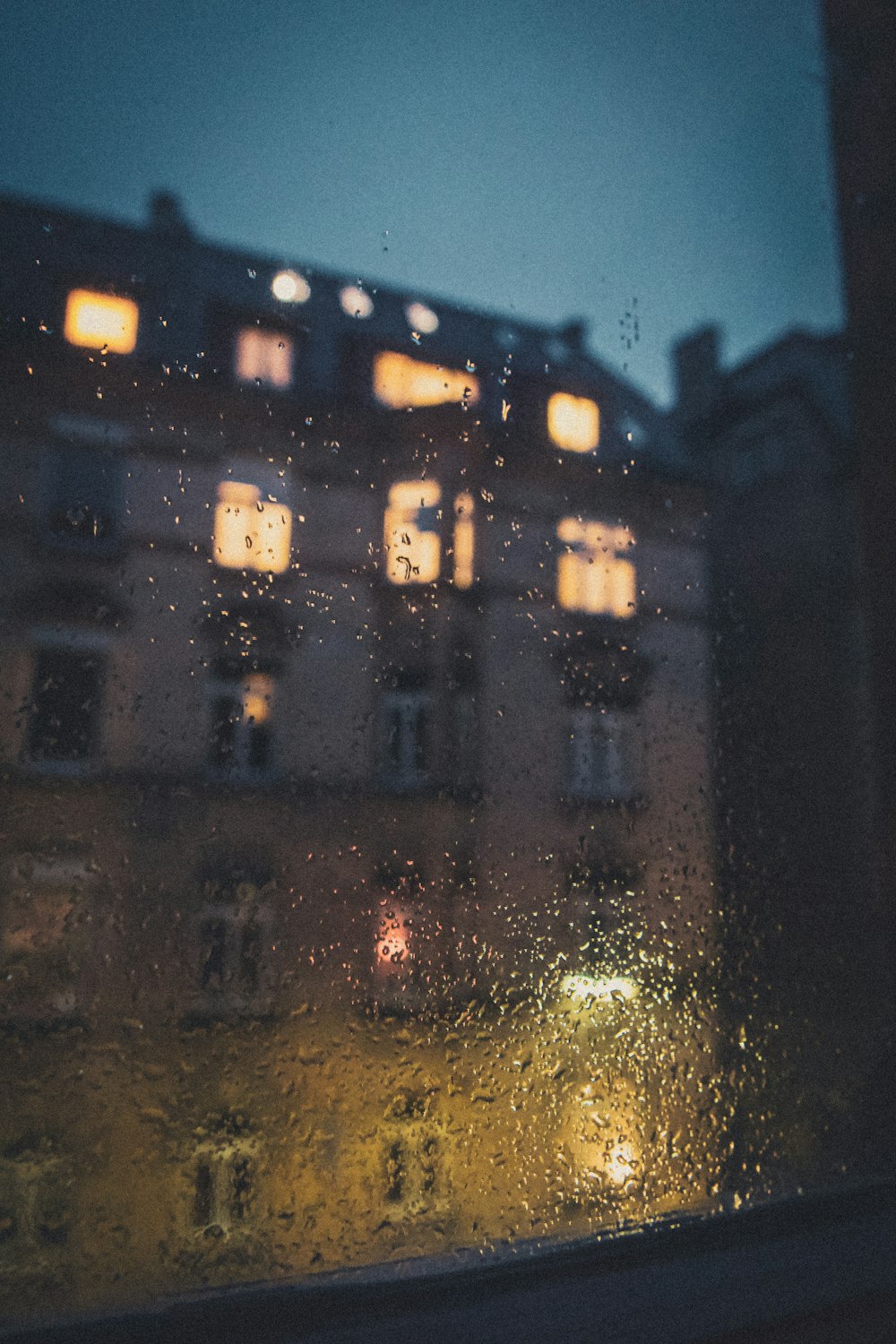 a building seen through a window at night