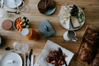a wooden table topped with plates of food