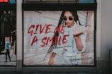a poster of a woman giving the peace sign