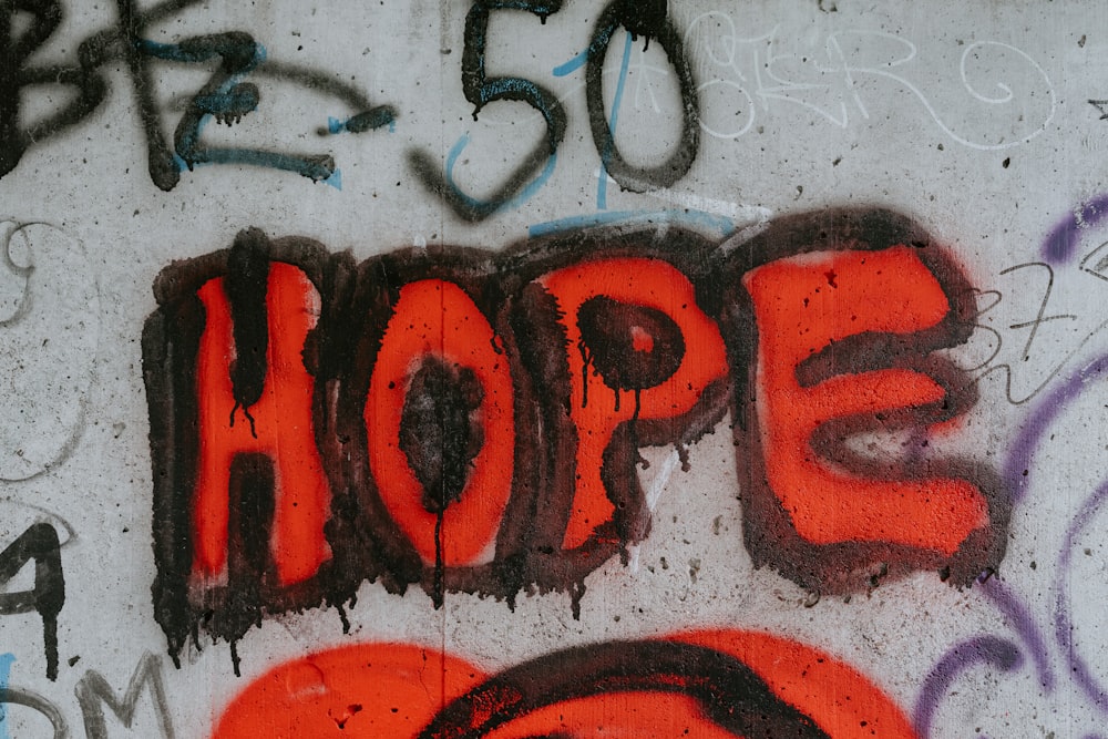 graffiti on a wall with the word hope painted on it