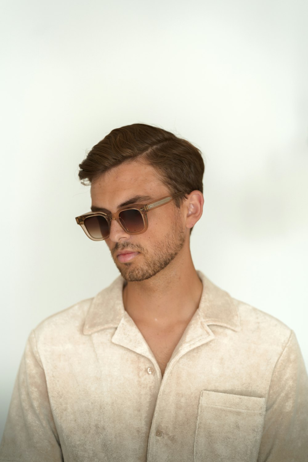 a man in a white shirt and sunglasses