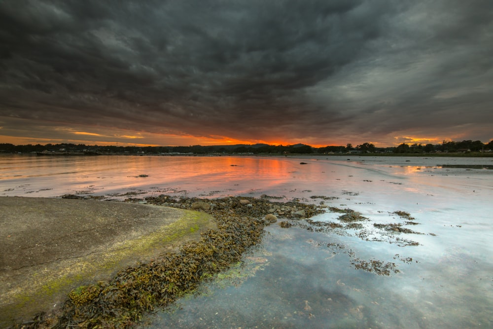 a large body of water under a cloudy sky