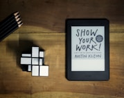 a tablet with a book titled show your work