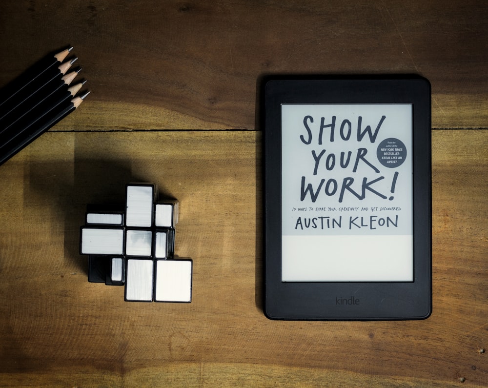 a tablet with a book titled show your work