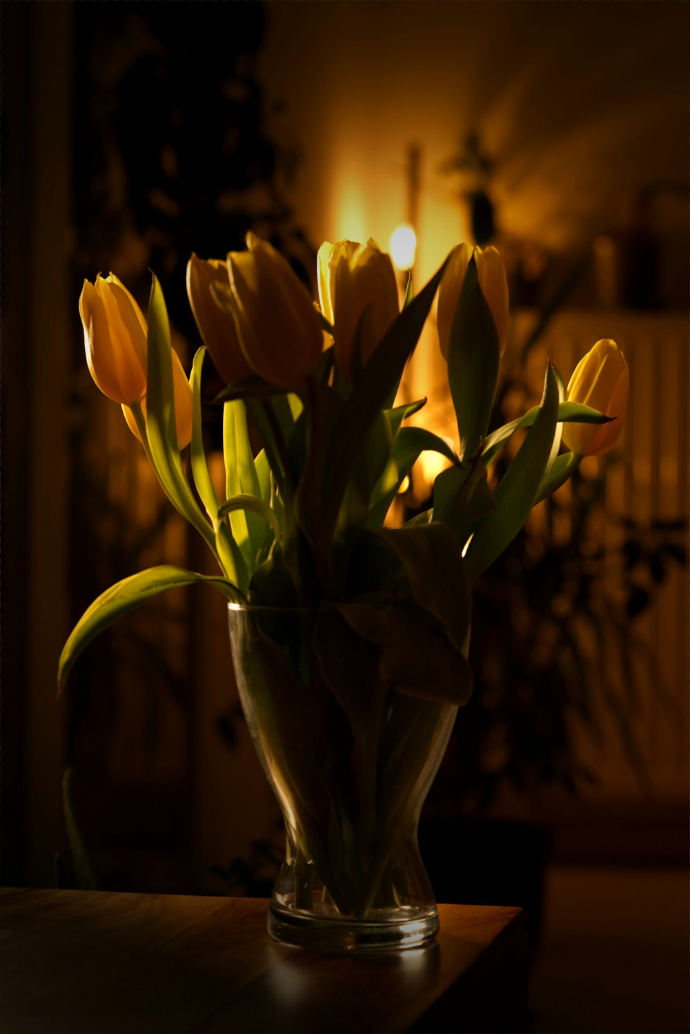 a vase filled with yellow flowers on top of a table