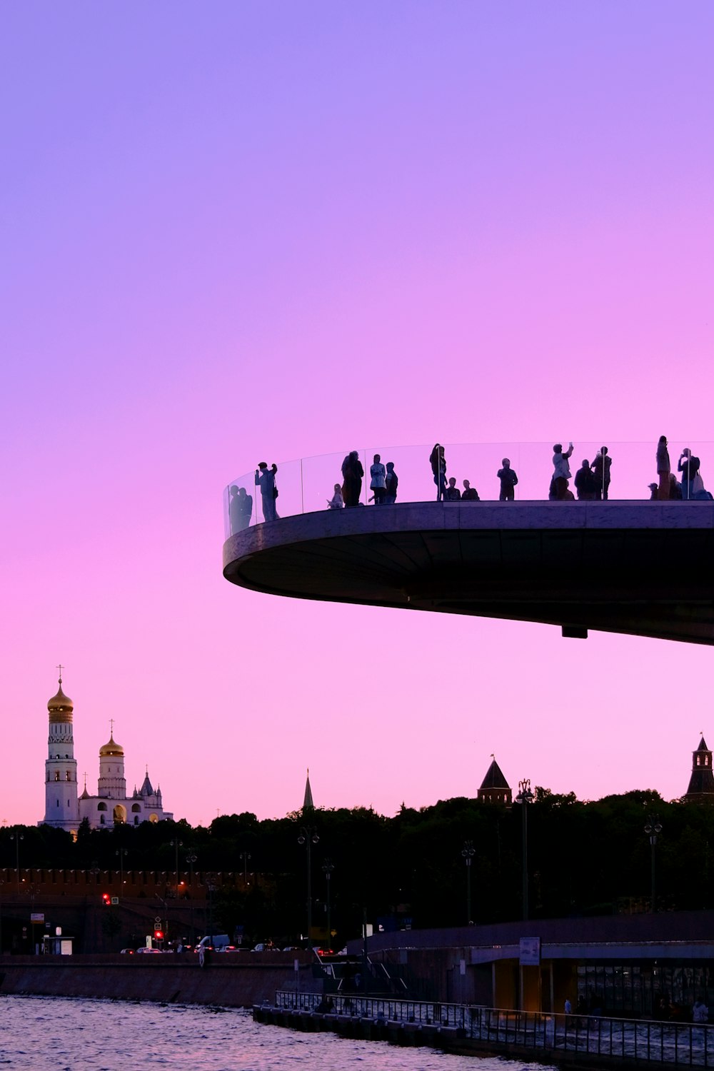 a group of people standing on top of a bridge