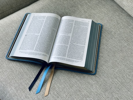 an open book sitting on top of a couch