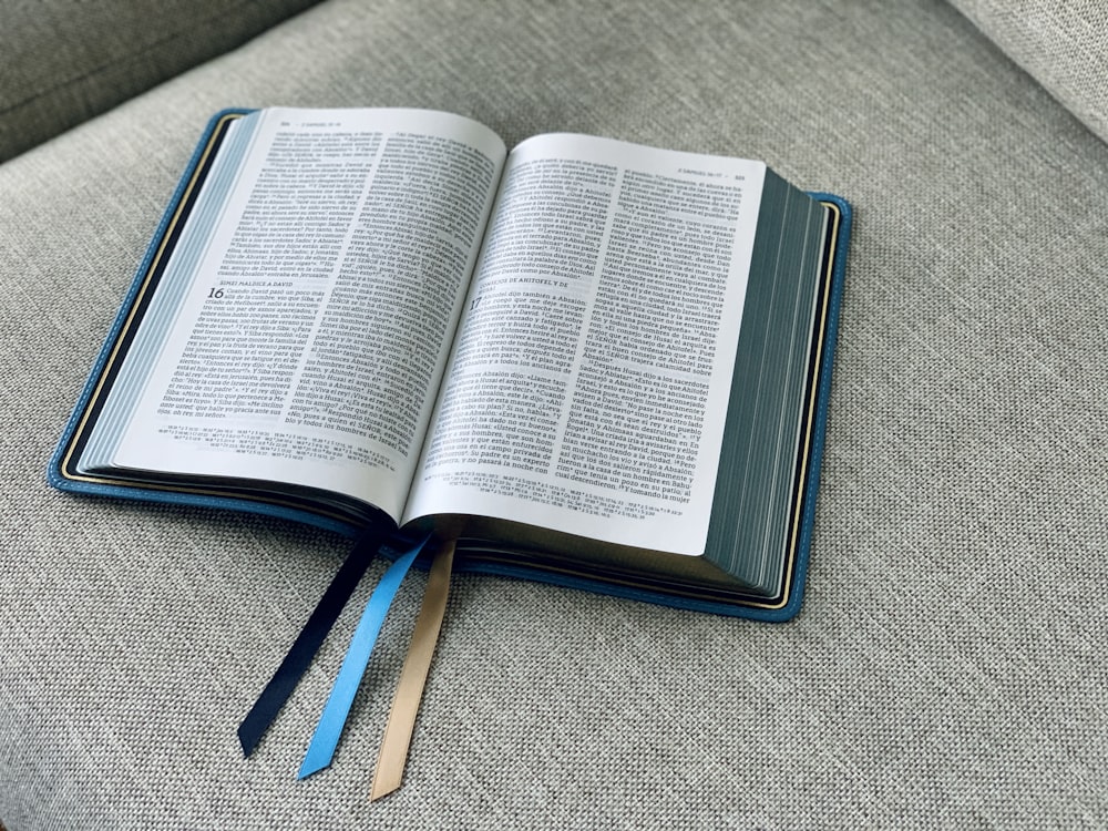 an open book sitting on top of a couch