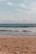 a person walking on the beach with a surfboard