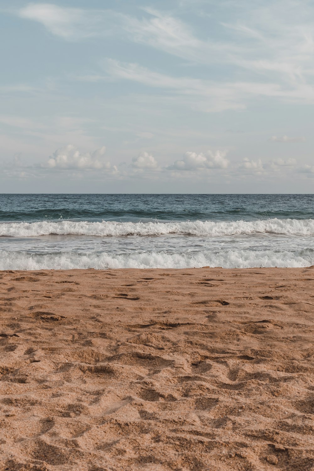 a beach with waves coming in to shore