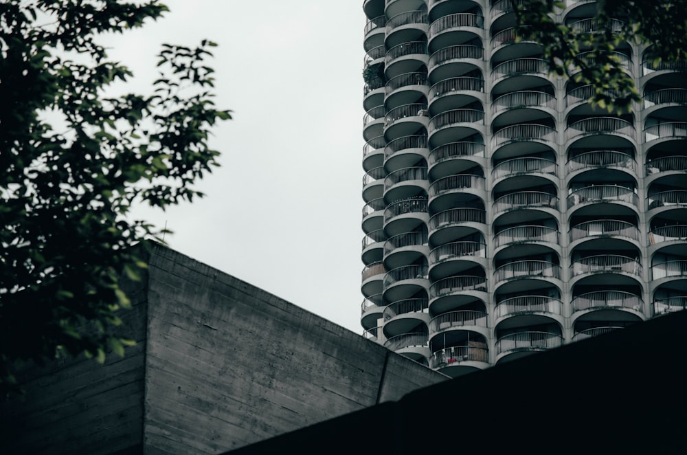 a very tall building with many balconies on it