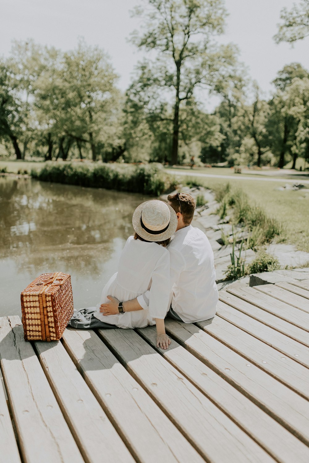 a person sitting on a wooden bench