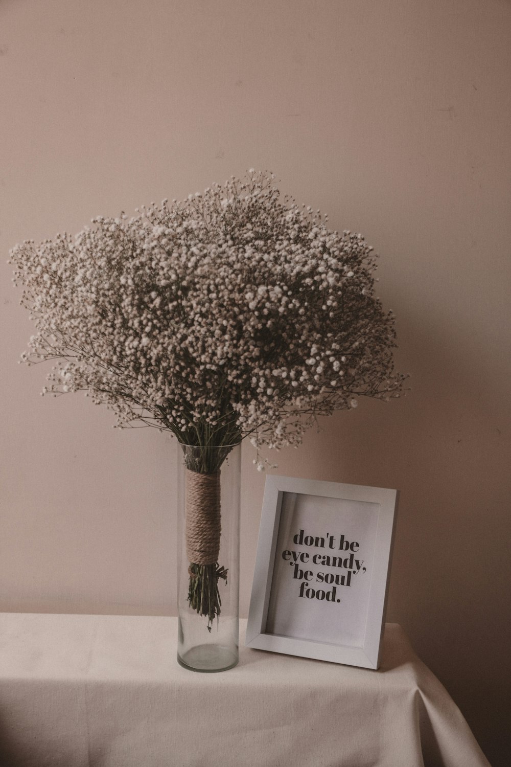 a vase filled with baby's breath sitting on a table