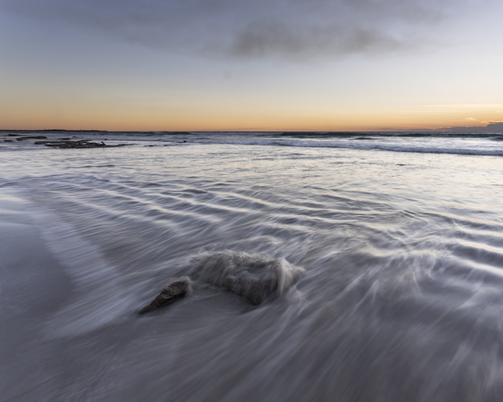 a beach with waves coming in and out of the water