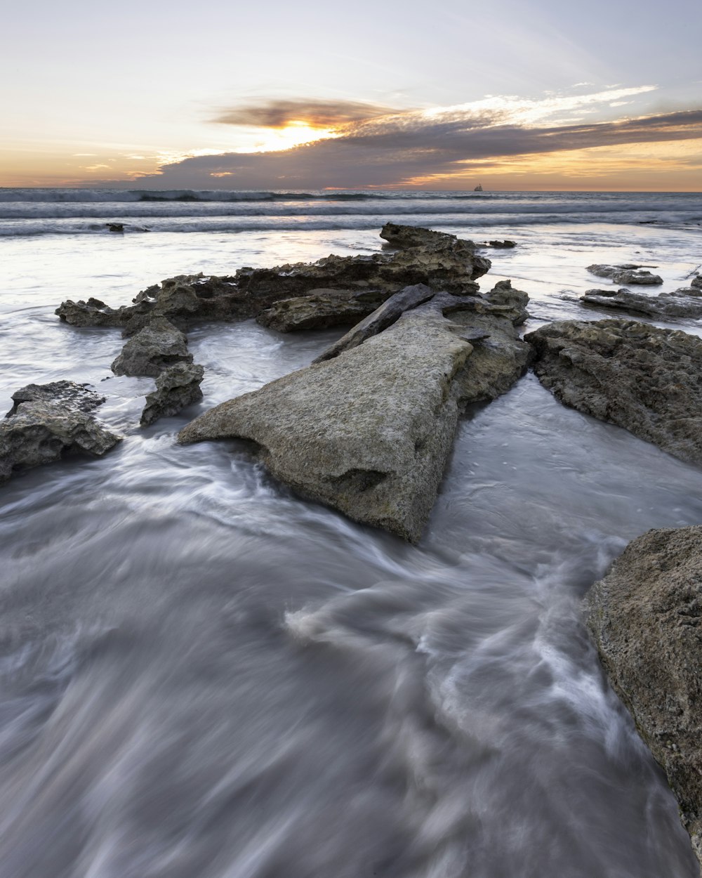 a long exposure photo of a rocky beach