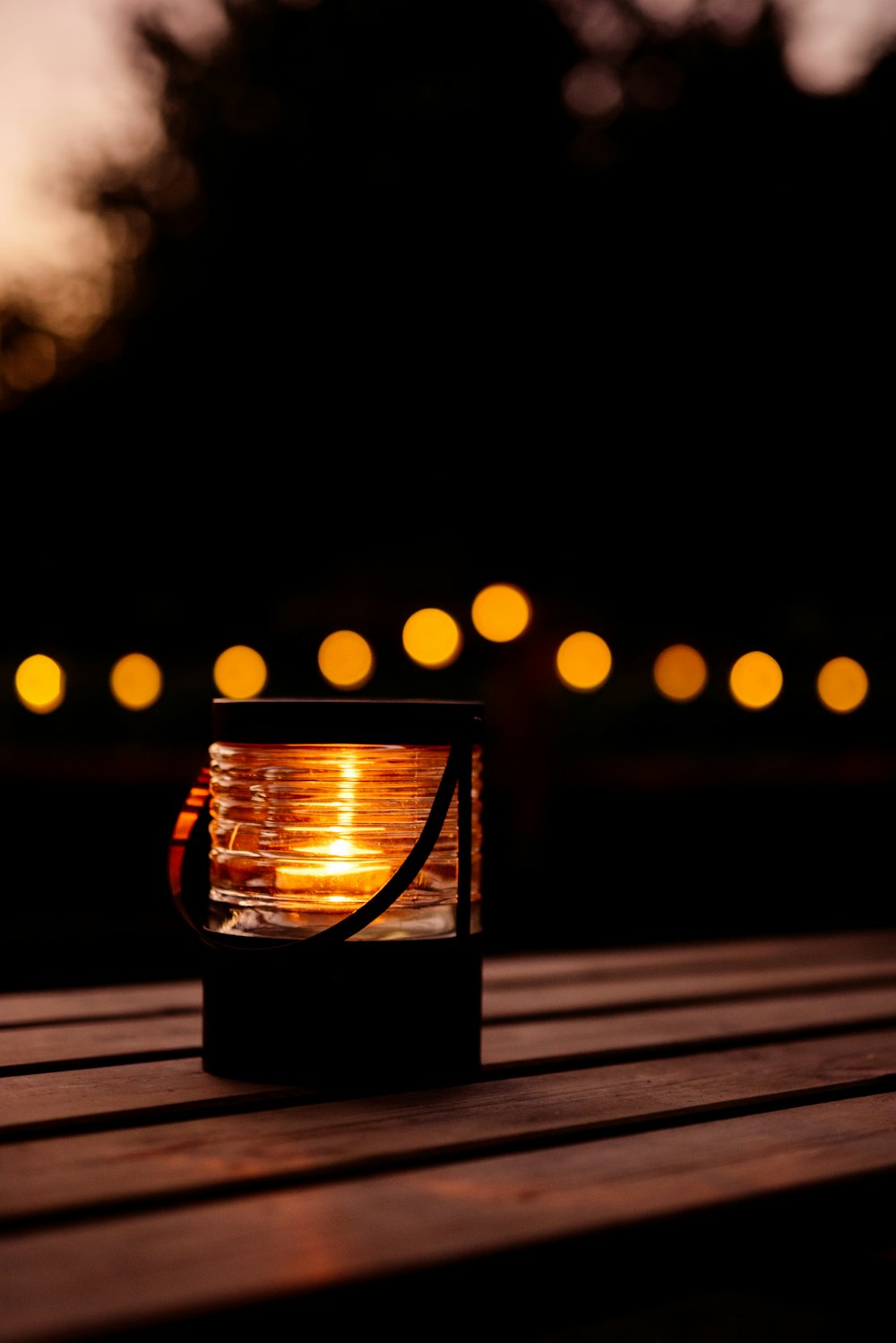 a lantern sitting on top of a wooden table