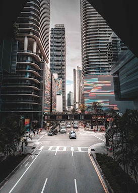 a city street with tall buildings in the background