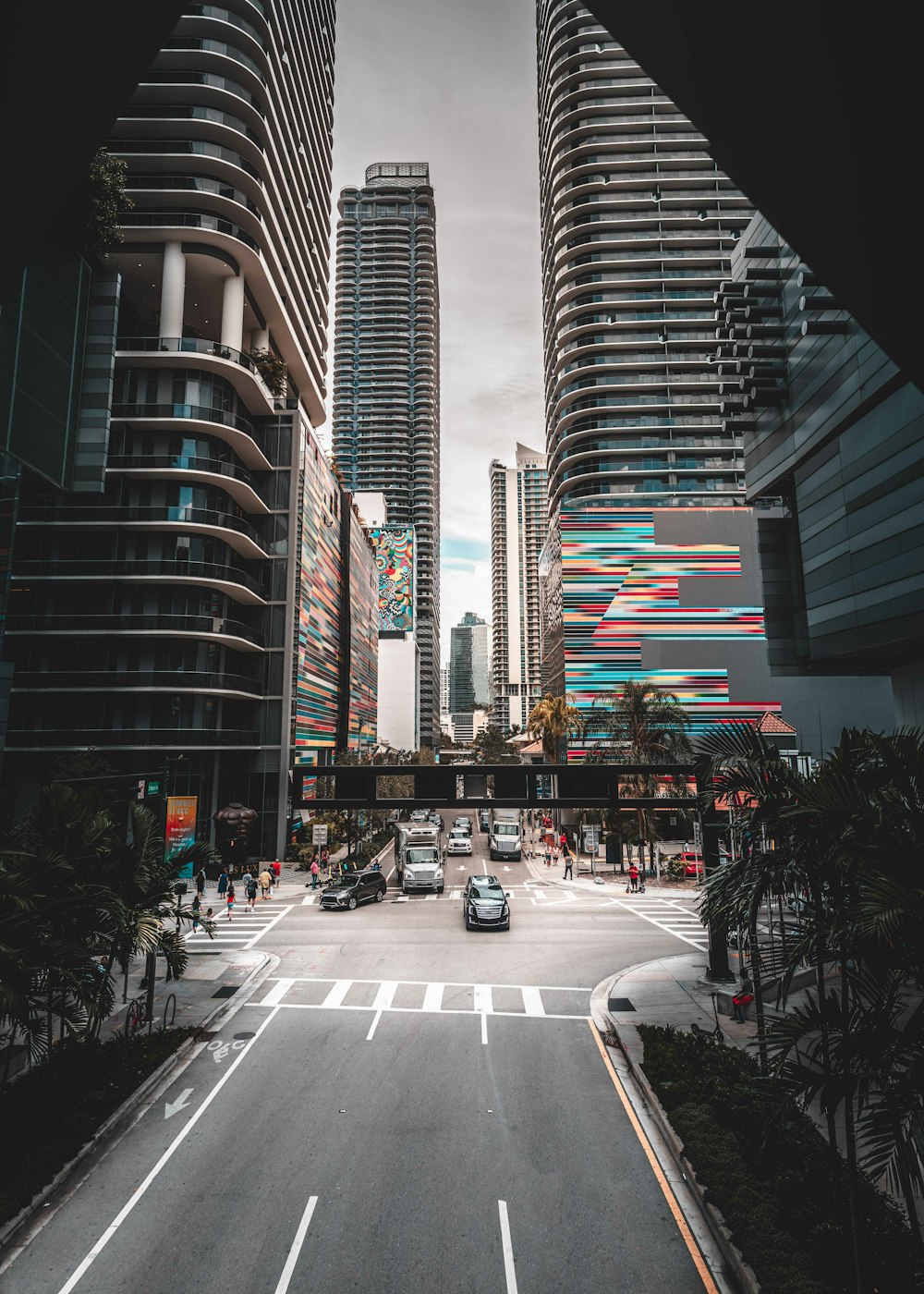 a city street with tall buildings in the background