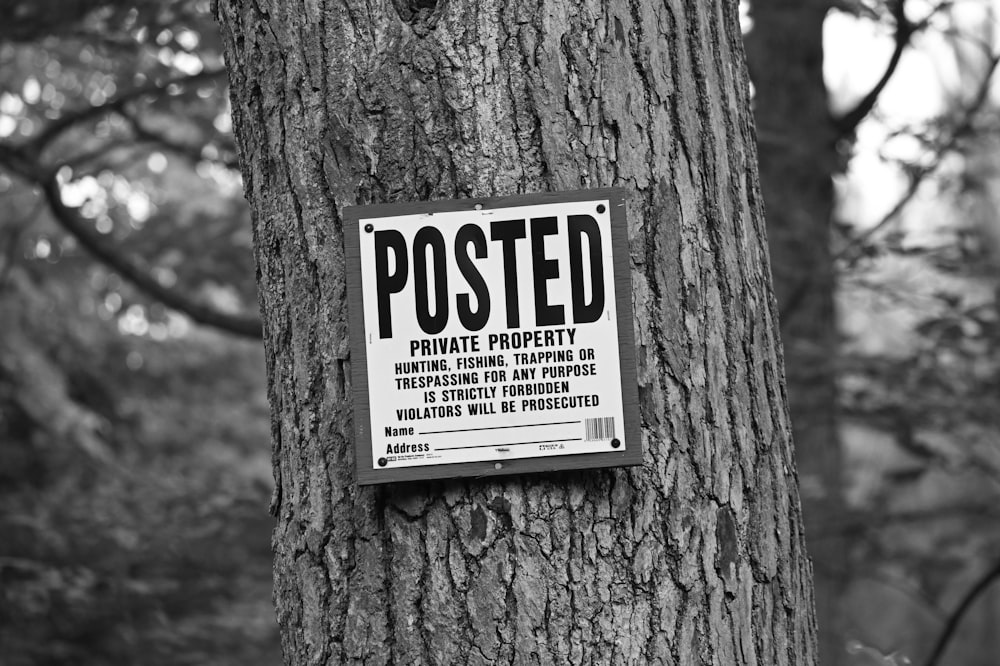a posted private property sign on a tree