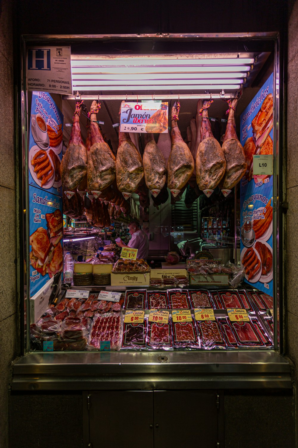 a butcher shop with meat hanging from the ceiling